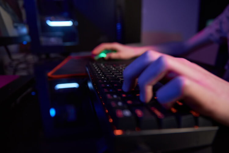 gamer's hands on mechanical keyboard