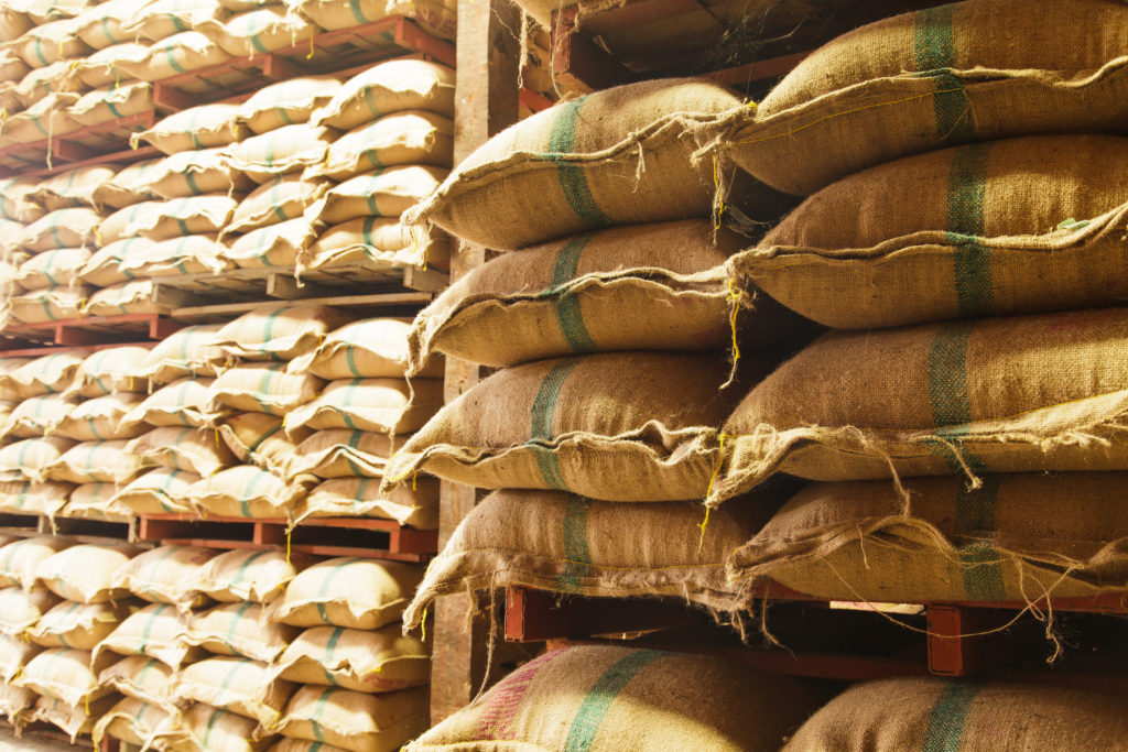 Stack hemp sacks of rice in the warehouse.
