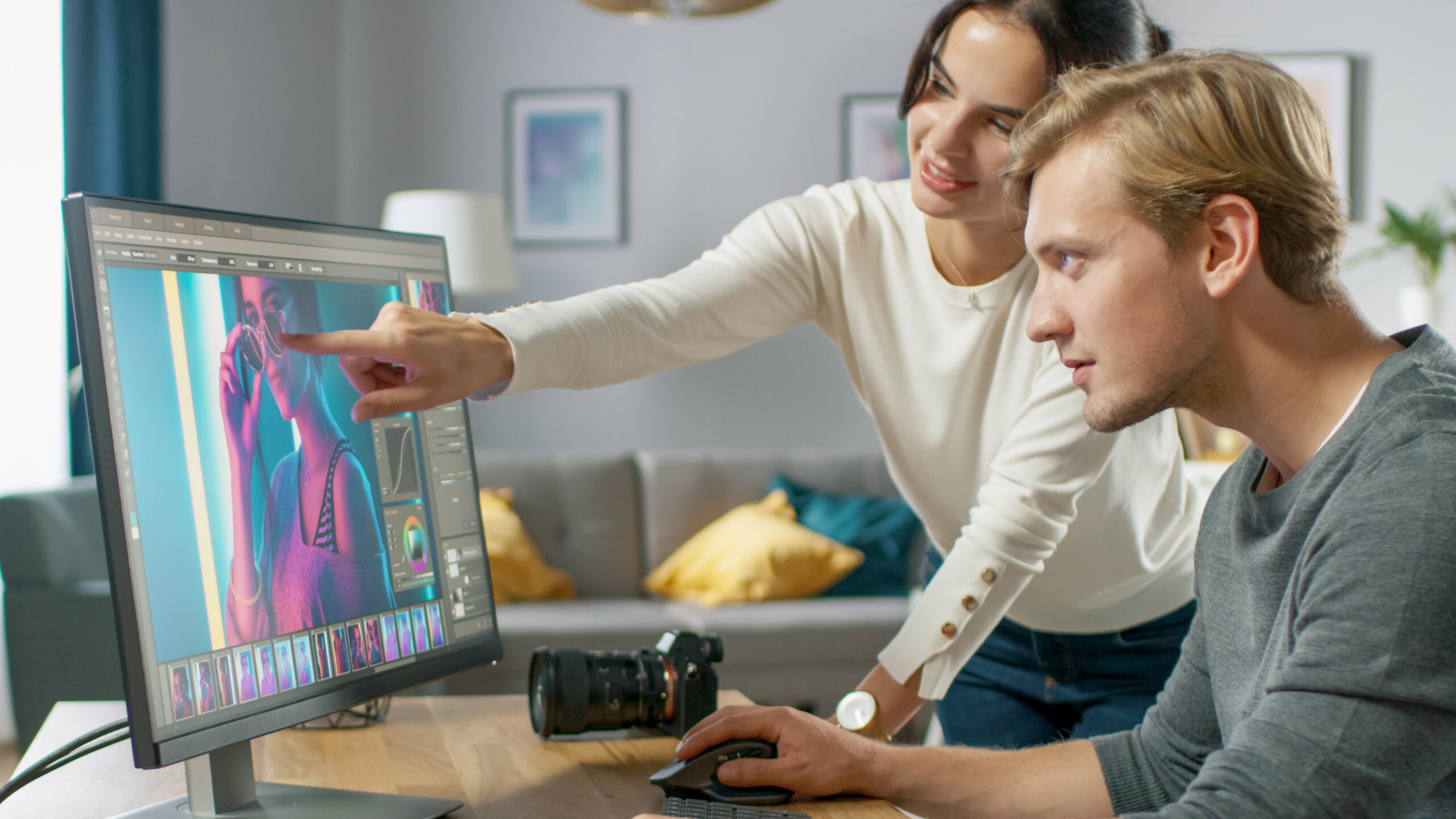 Male and Female Professional Editors Talk while Working in Photo