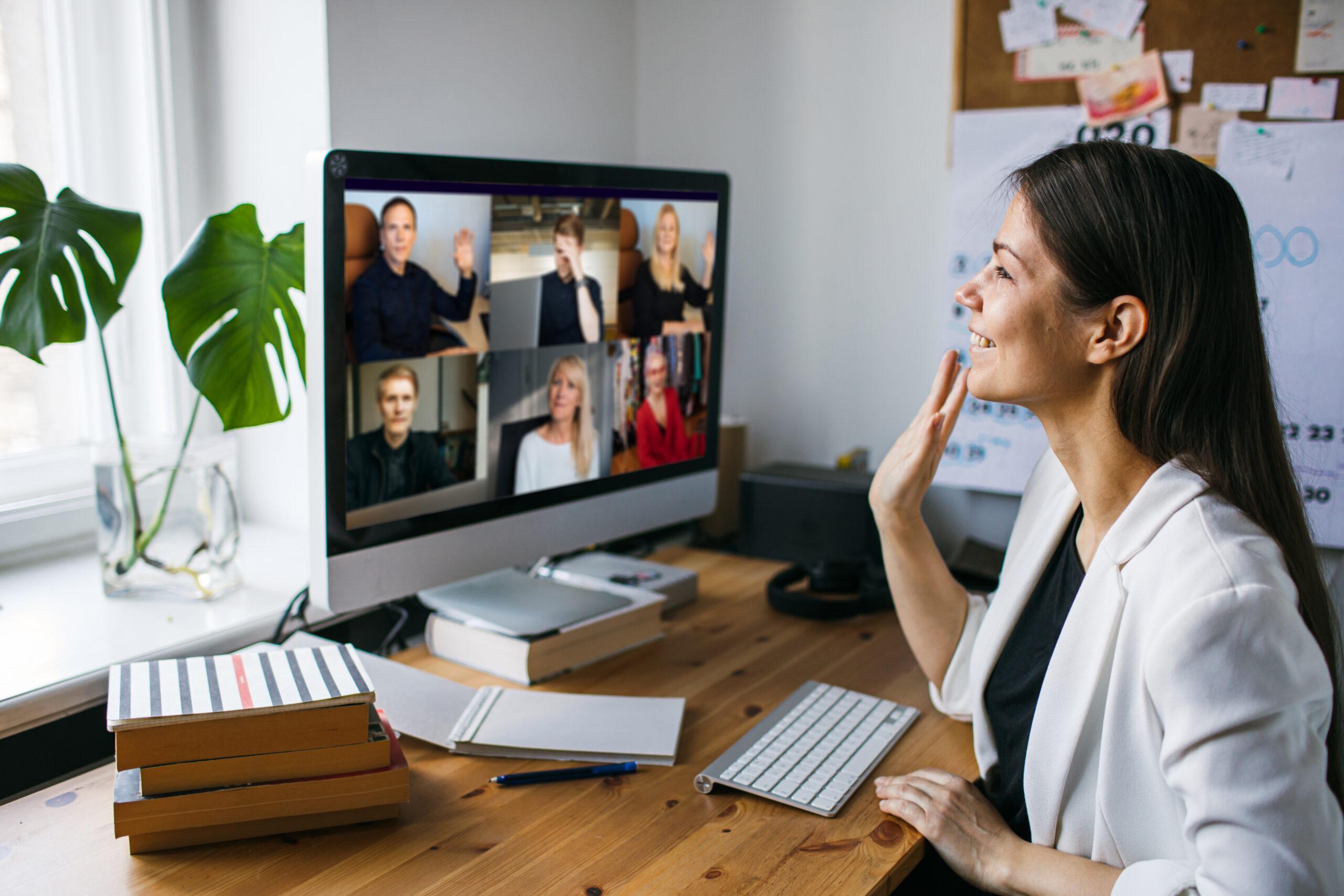 Young woman having Zoom video call via a computer in the home of