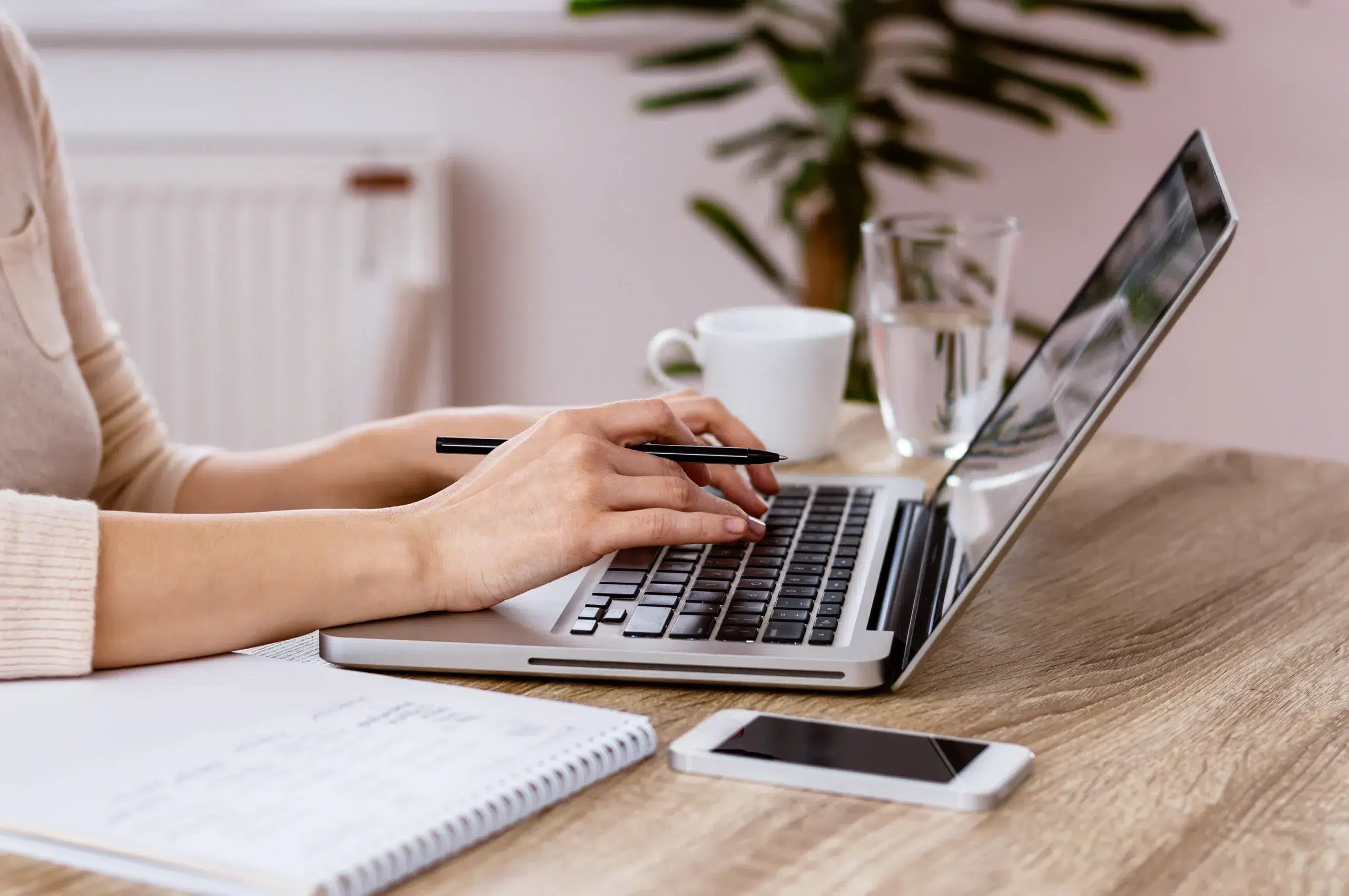 Woman's hands typing on a laptop