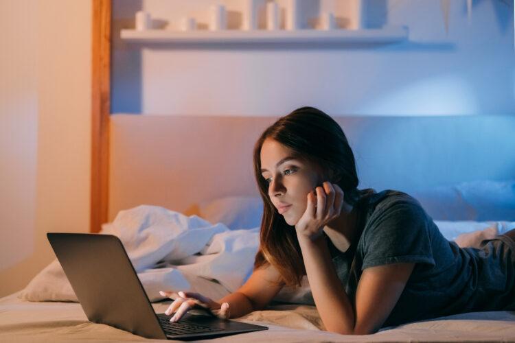 woman spending night online in bed at home