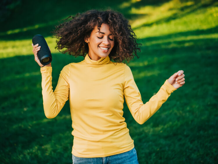 Young beautiful woman enjoying, dancing in park.