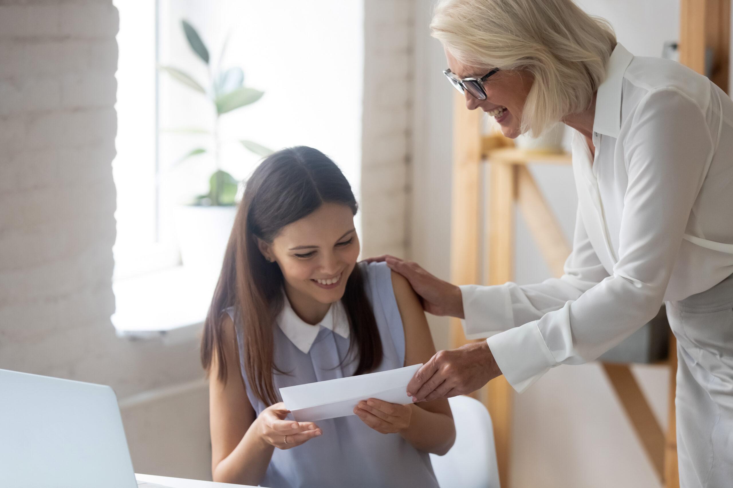 Excited female employee get monetary gratitude from boss