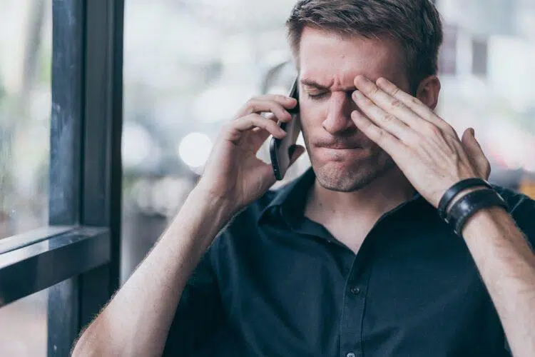 stressed guy and angry while on a call on his cell phone