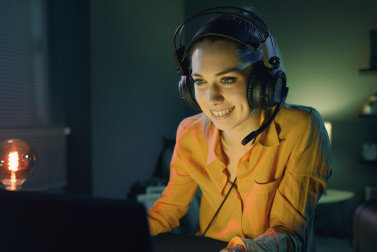 Cheerful woman playing video games online