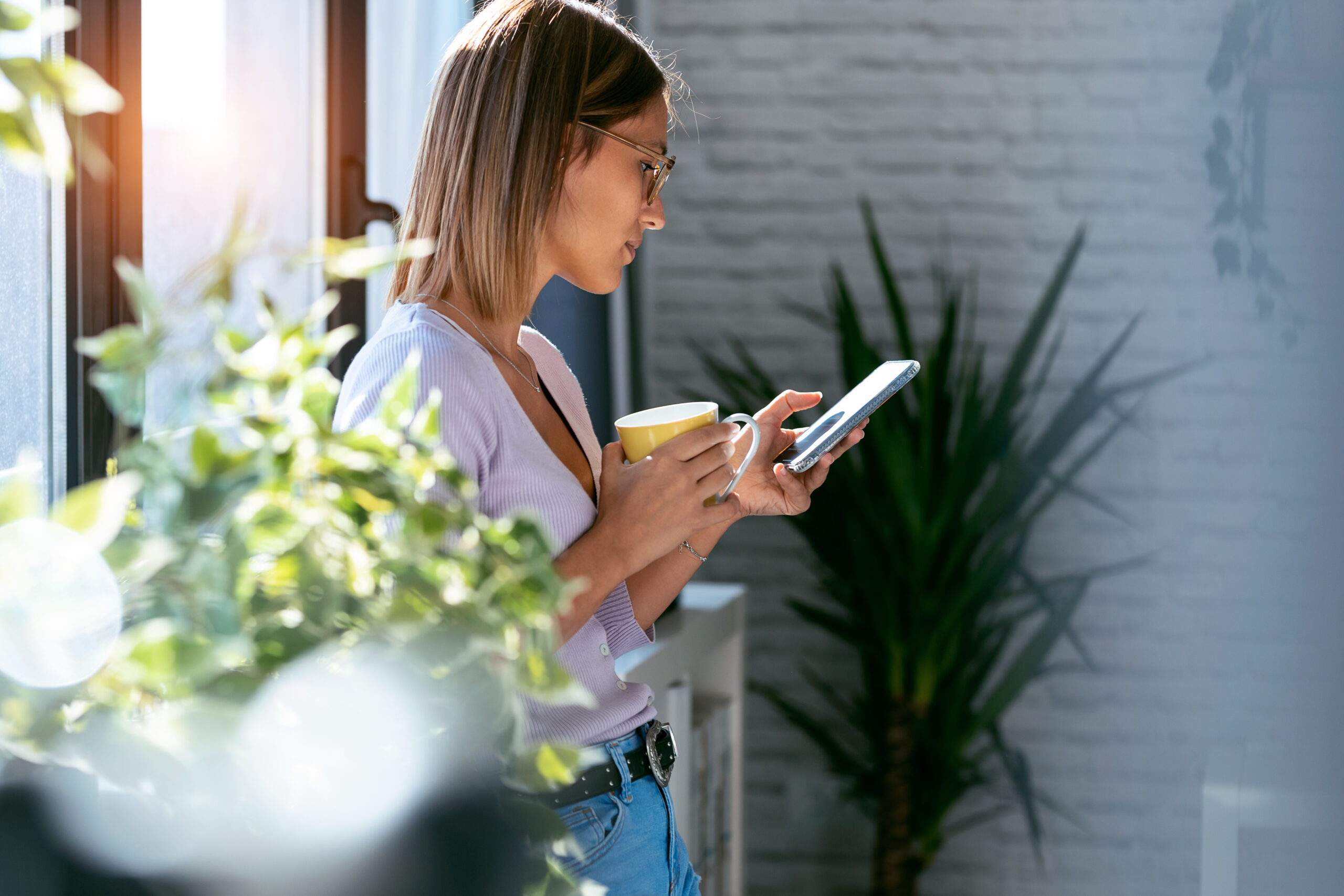 Beautiful young woman using her mobile phone, checking something