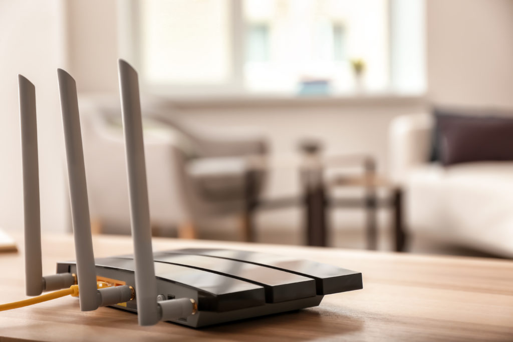 Modern wi-fi router on wooden table in room visually depicting one of the most common causes of Instagram's ingress timeout stream id message.