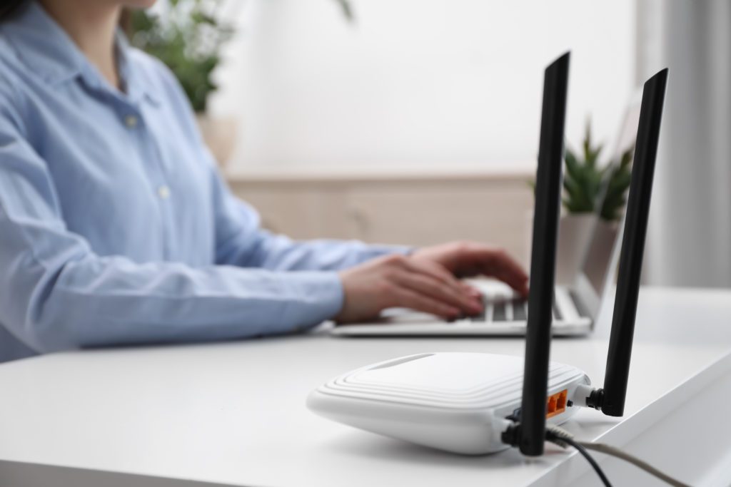 Internet router with woman working in the background.