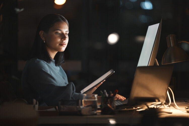 Female computer tech working on database with her new understanding of dmz vs port forwarding..