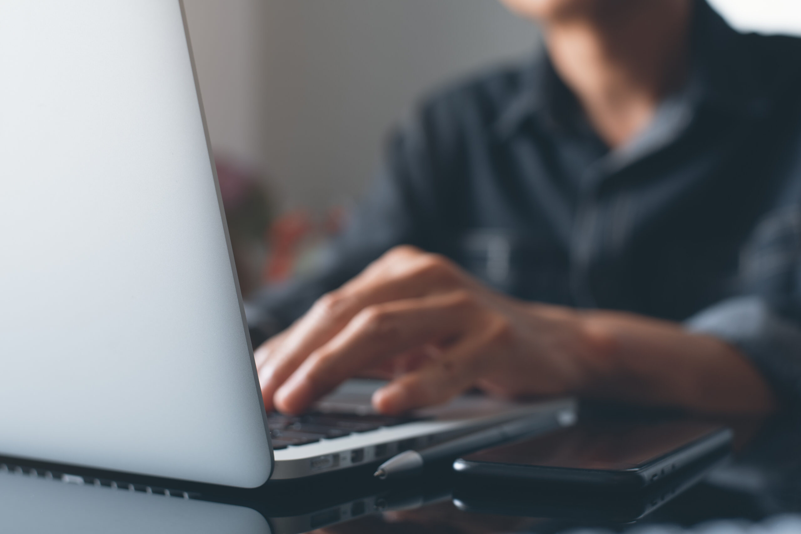 male hands typing on his laptop