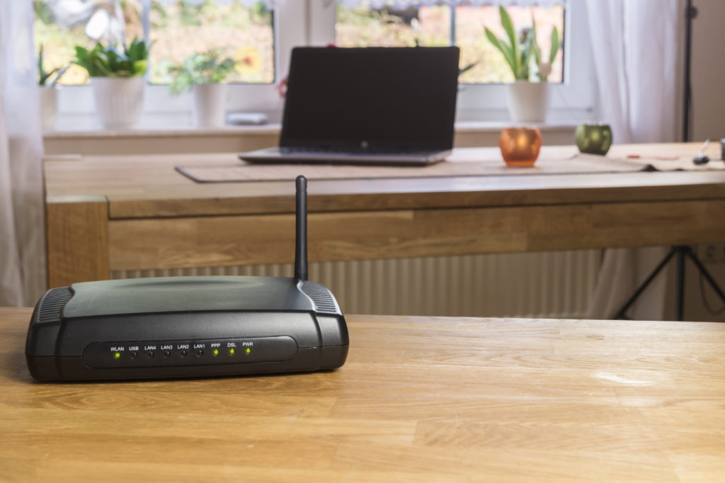 Wireless modem router on a wooden table.