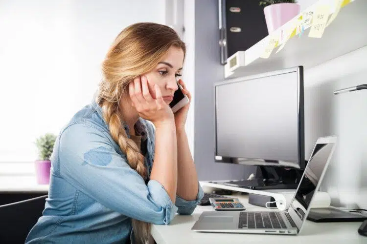 Stressed woman on the phone at home 