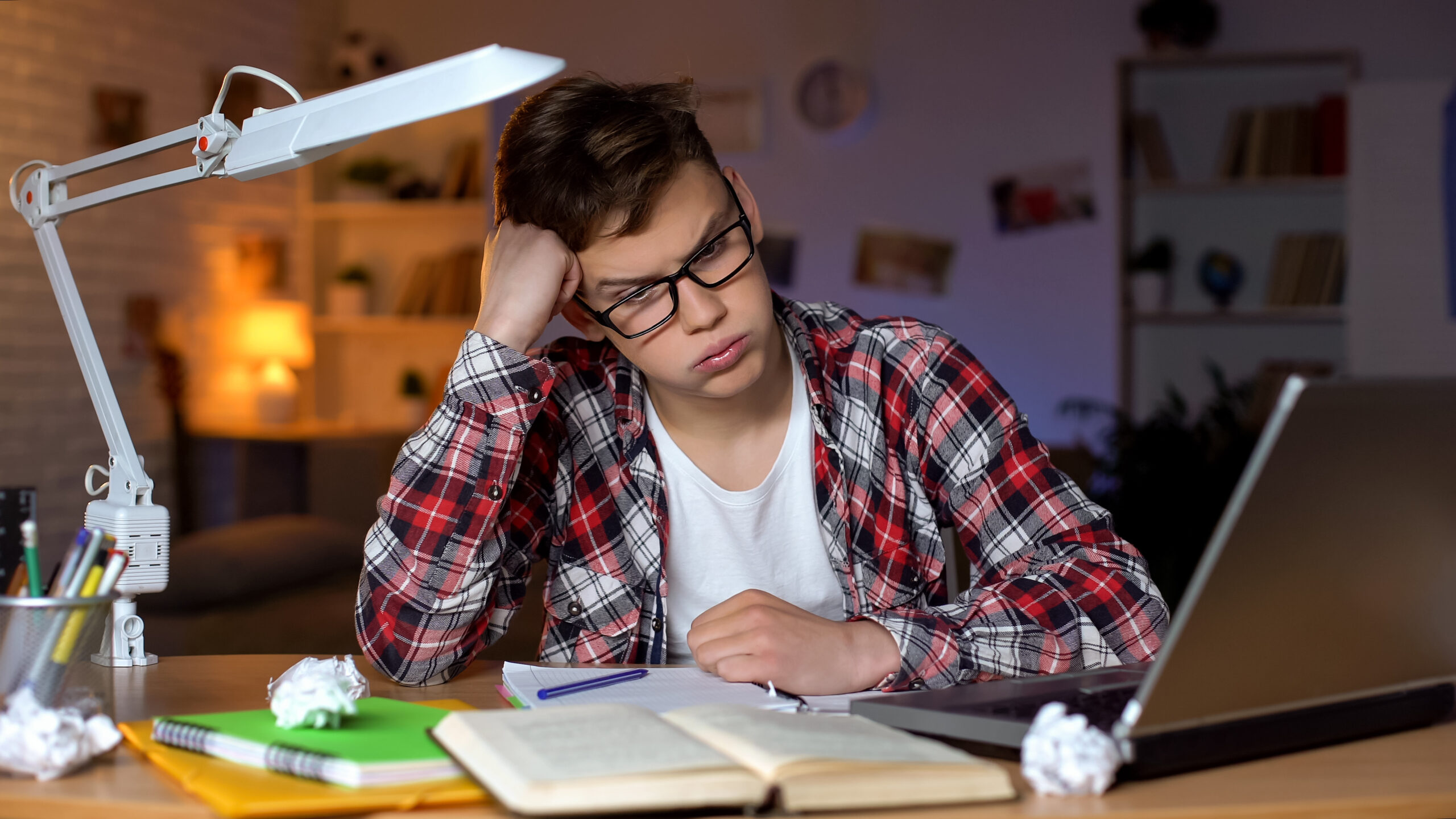 Anxious teenager student trying to solve difficult math assignme