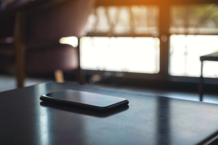 a black mobile phone on the table