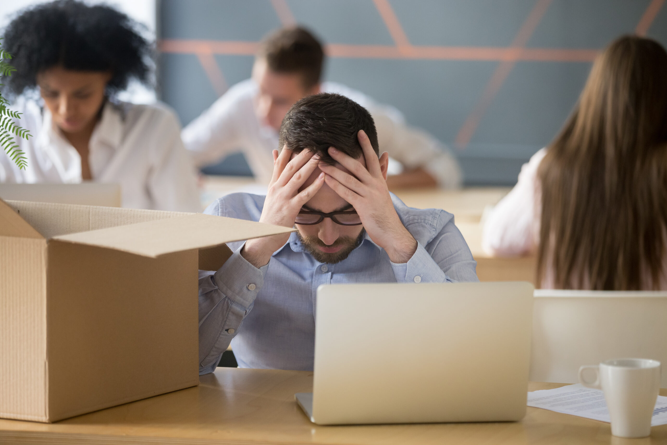 Upset male employee stressed being fired from work