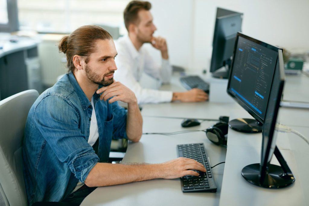 Programmers working, looking intently at their computers.