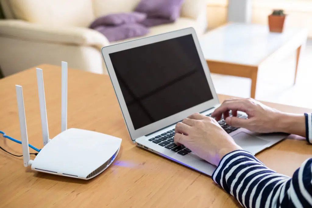 A WIFI router and a laptop that's being used.