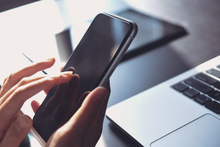 Business woman hand using mobile phone, finger touching on screen