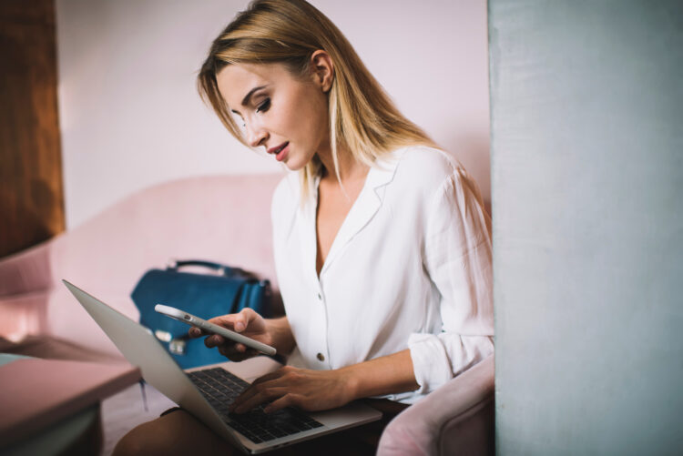 Stylish woman using laptop in office