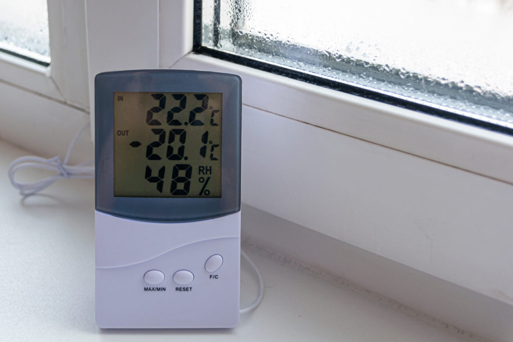 Home electronic thermometer shows the temperature outside -20 degrees of cold. 