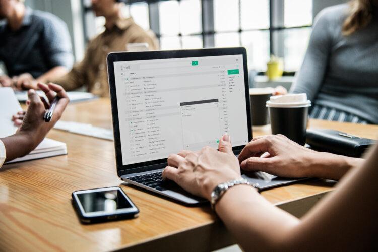 Woman checking her email in a meeting