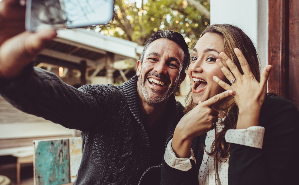 an engaged couple showing off their ring