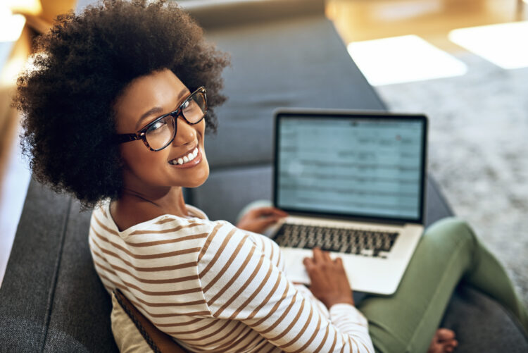 female office worker smiling while working on computer