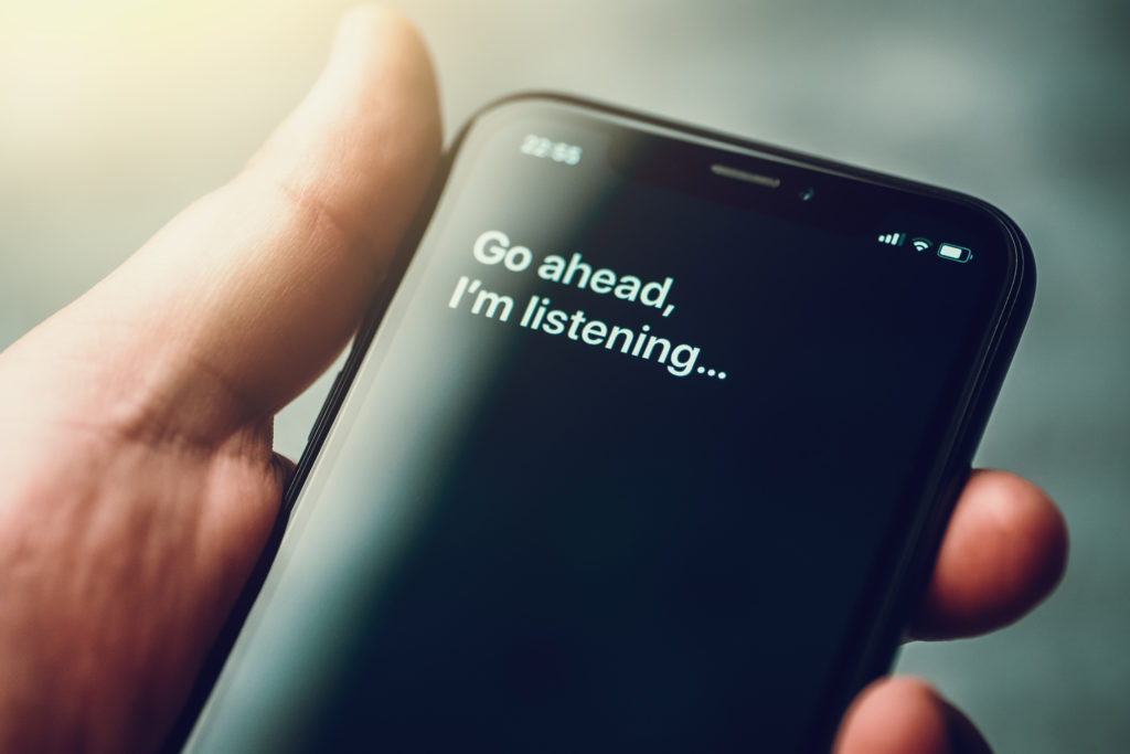 Text on smartphone screen: Go ahead, I'm listening..