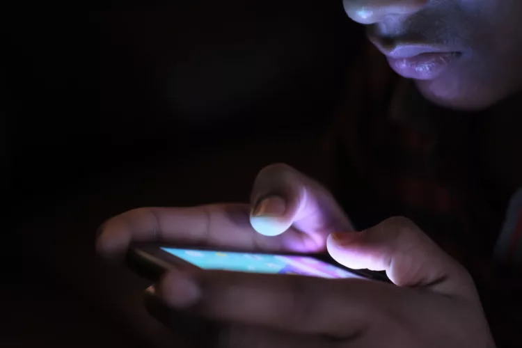 Man using his smartphone at night