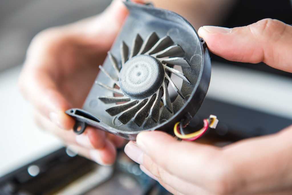 Computer repairman holding computer fan