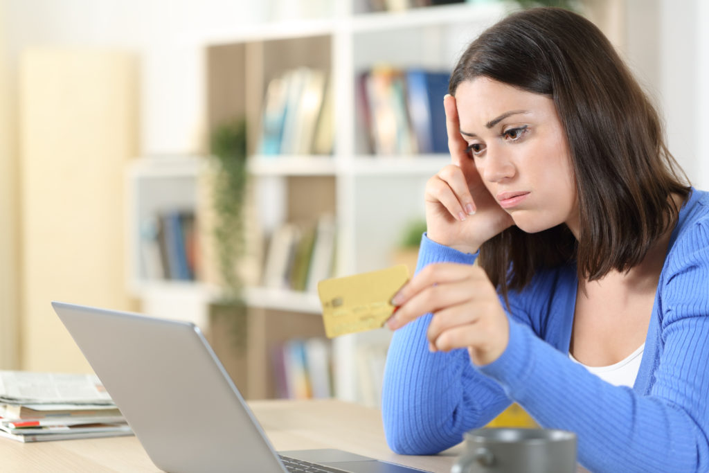 Worried woman having trouble paying with card