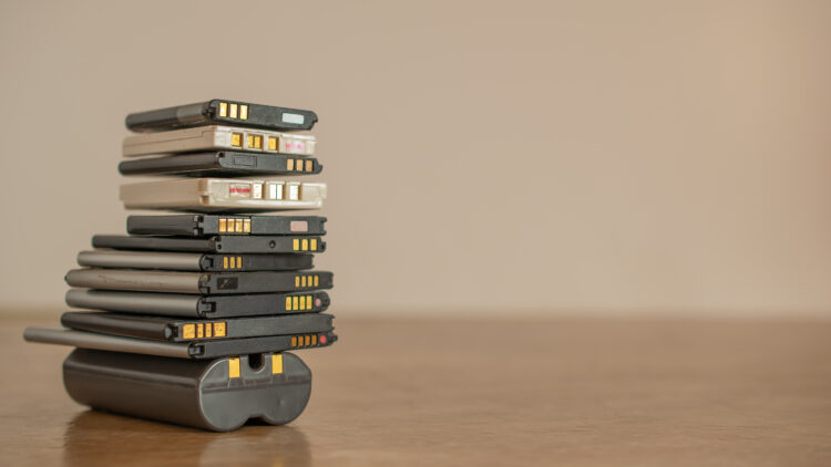 old cell phone batteries, stacked for recycling
