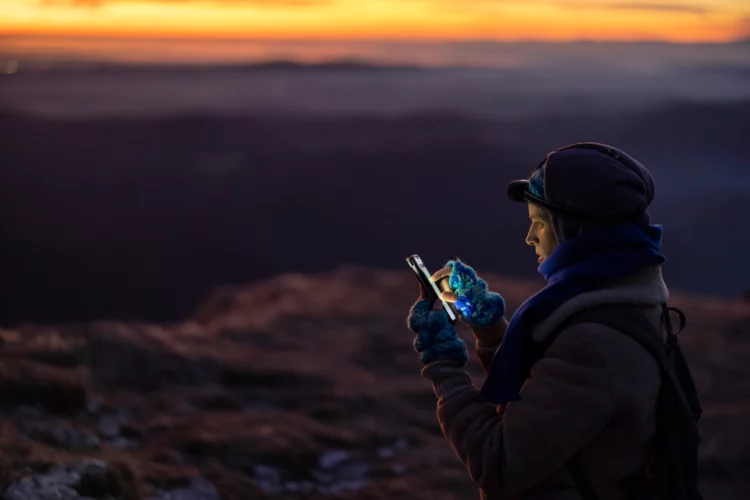 woman using cellphone in the mountain