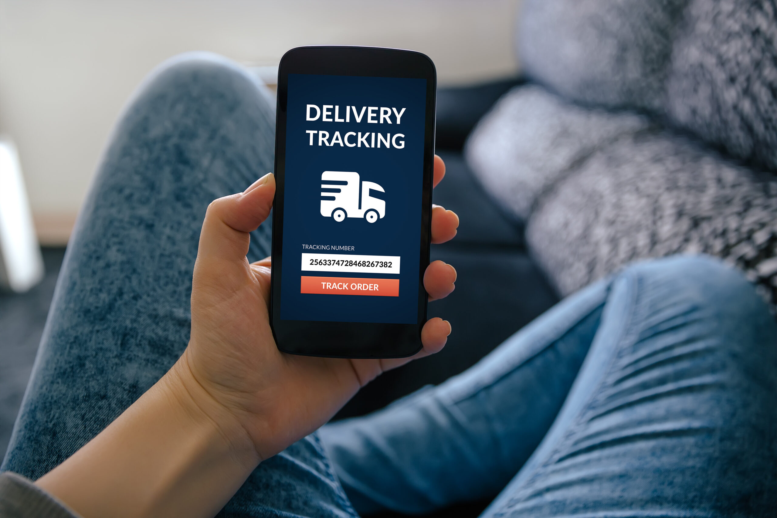 Girl holding smart phone with delivery tracking on screen