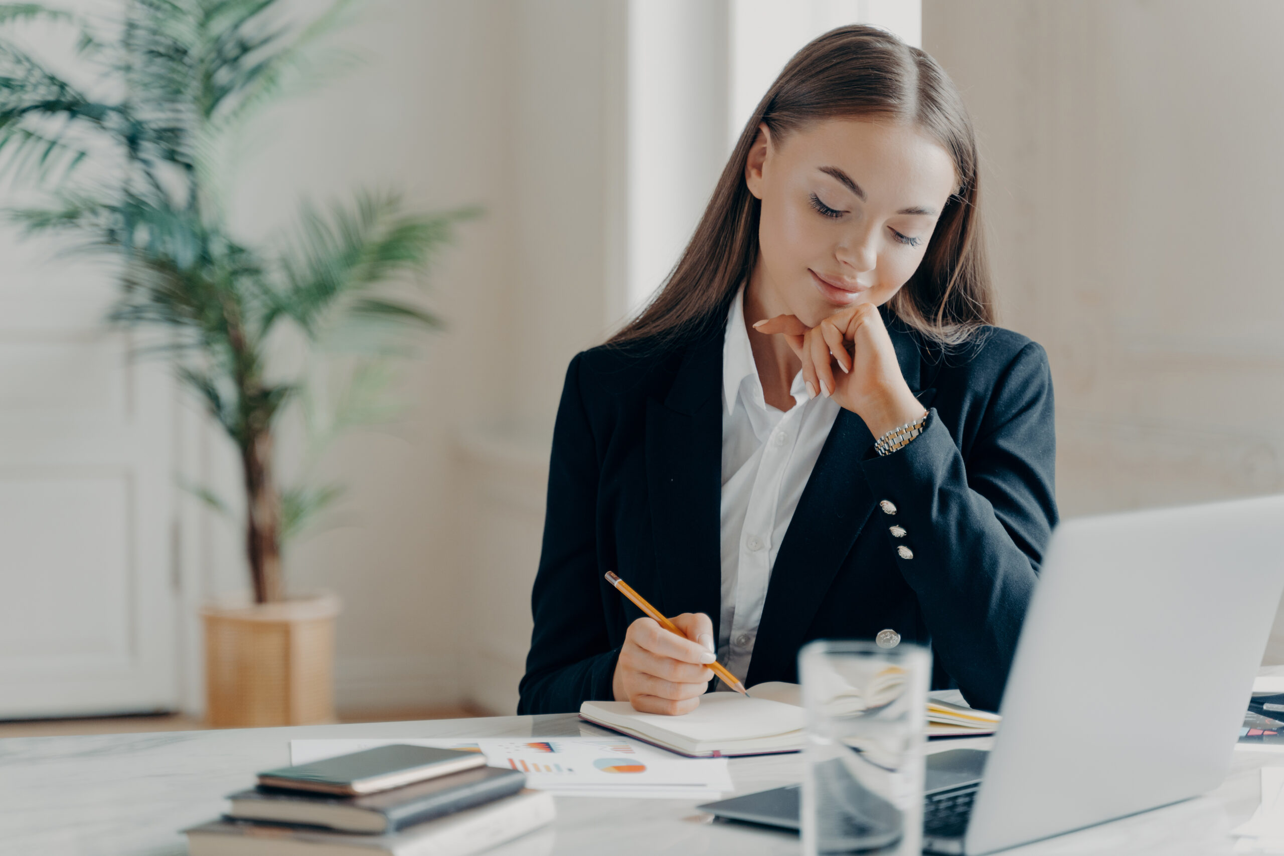 Concentrated business woman thinking about work issues at office