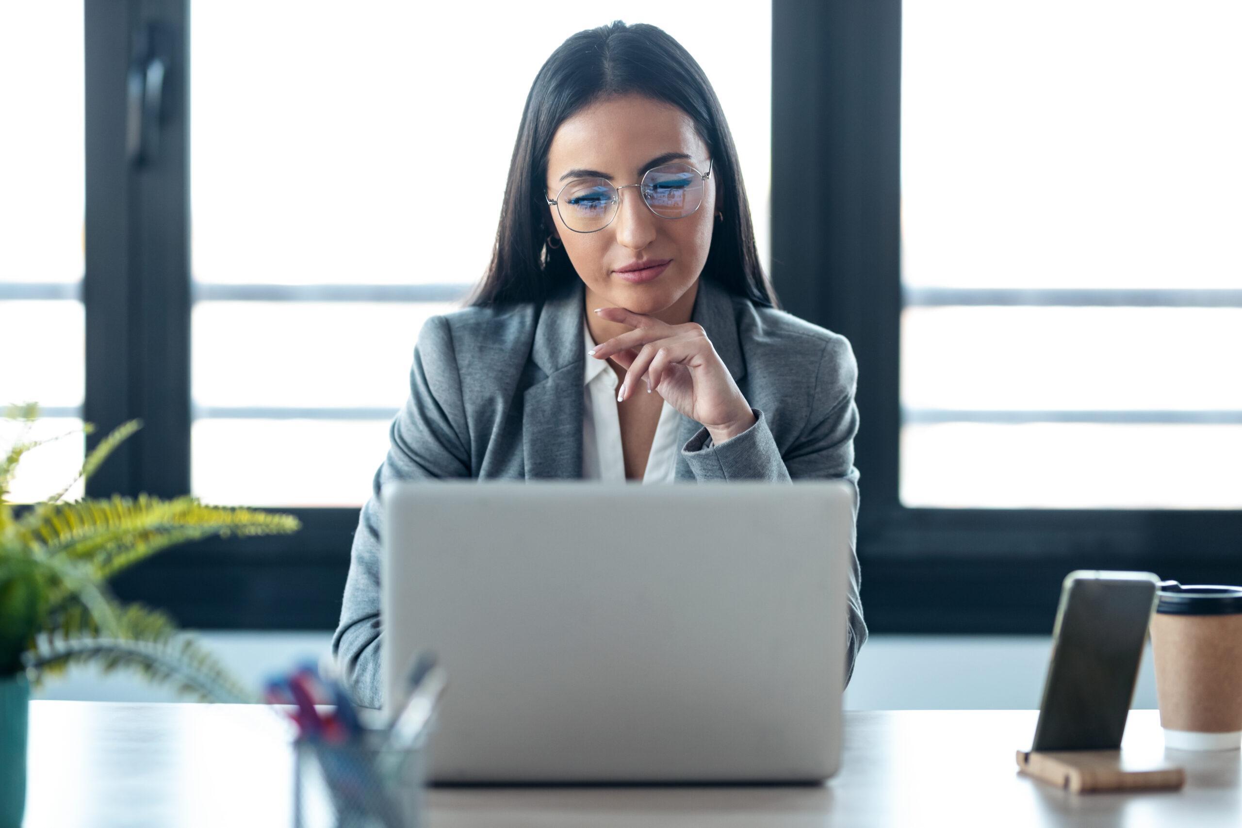 Confident business woman  working on her laptop