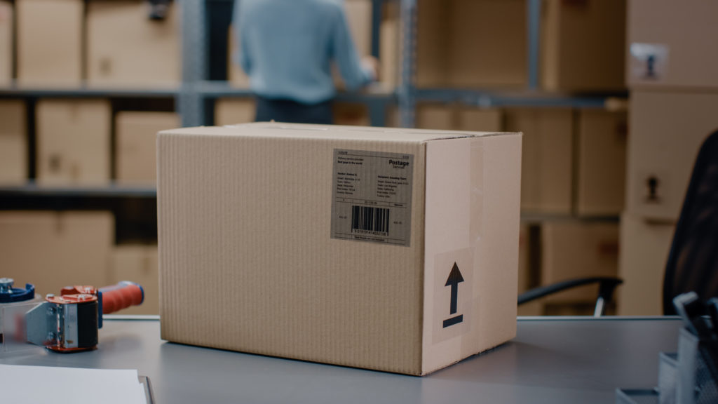 Cardboard box package on top of a warehouse table