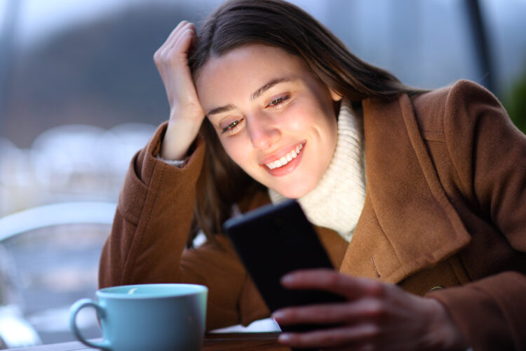 Happy woman chatting on phone outdoor