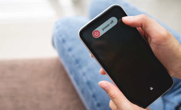 Woman hand turning off the phone