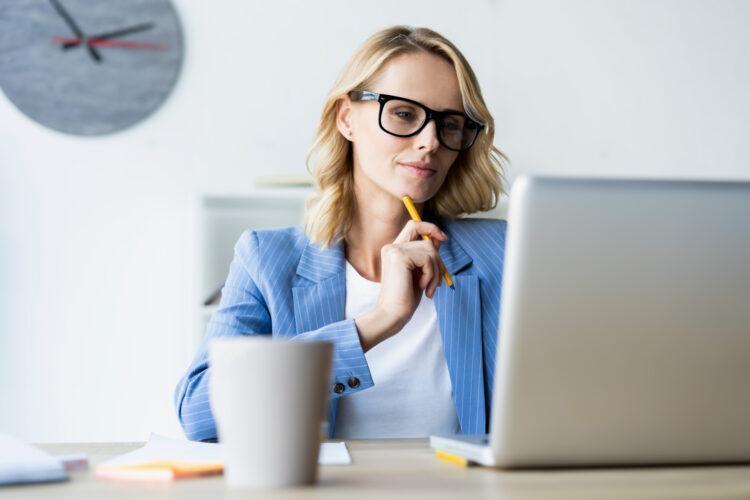 a serious businesswoman using laptop in office