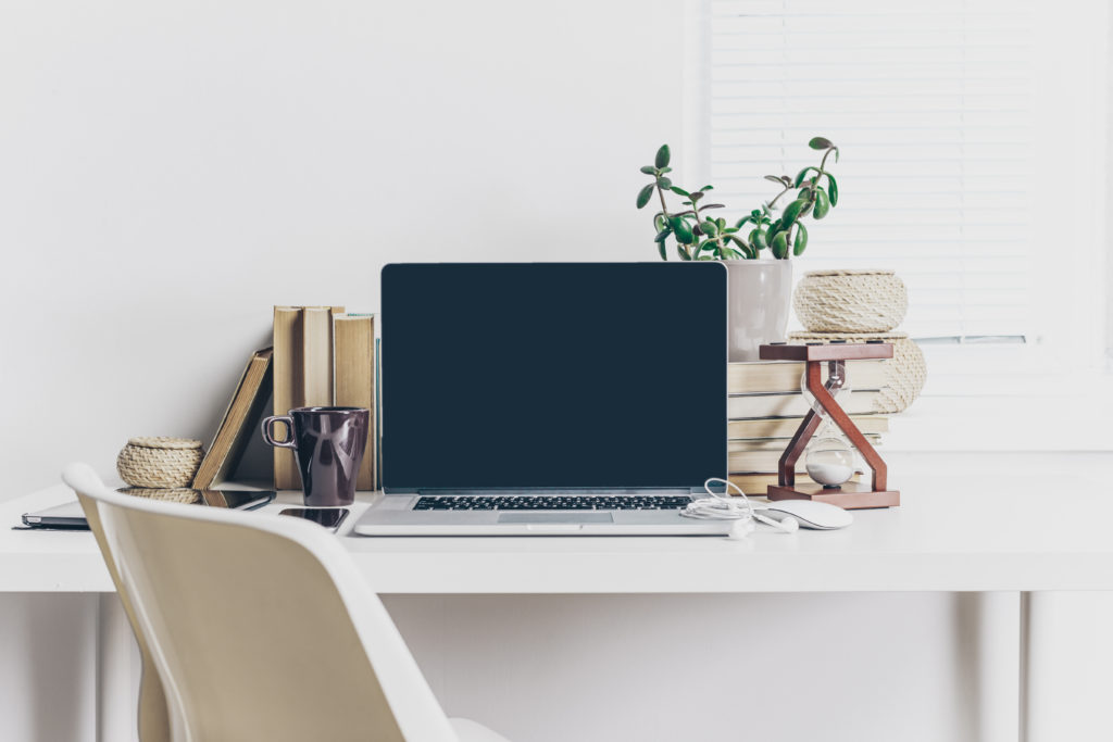 laptop on white desk at home workspace