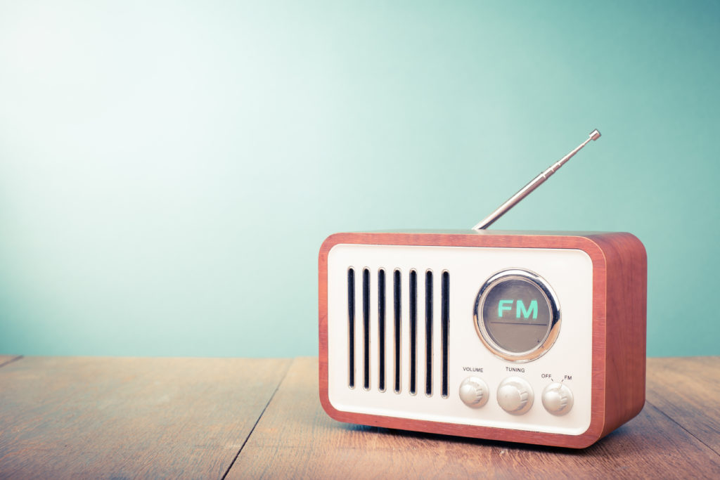Retro old radio front mint green background. Vintage style filtered photo.