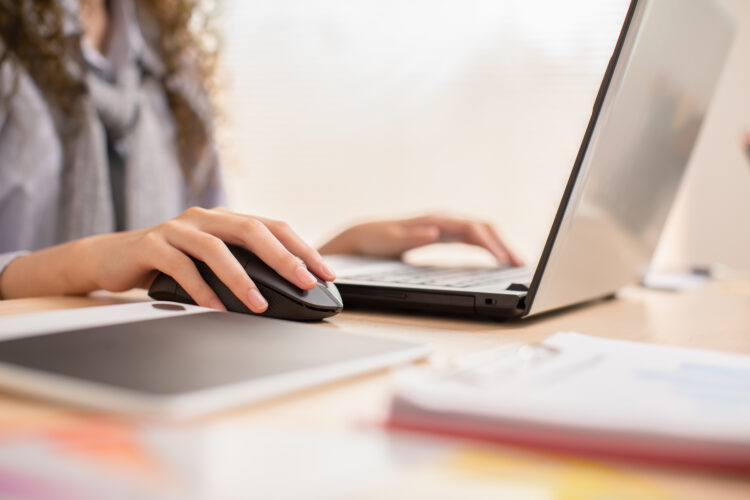 hand of young woman working on laptop