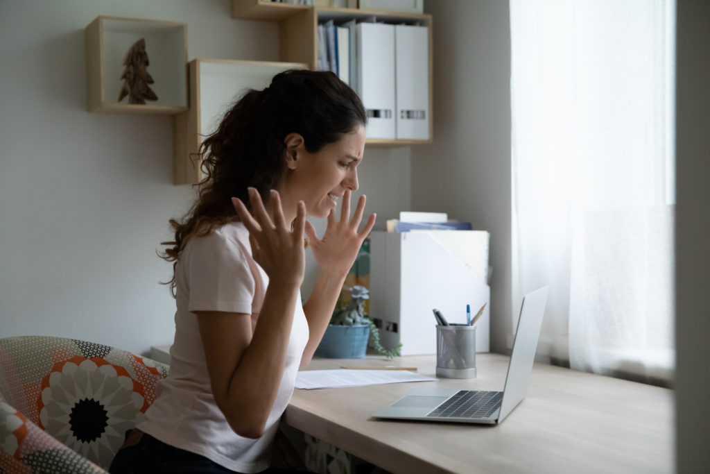 Annoyed young lady unable to work online having slow internet