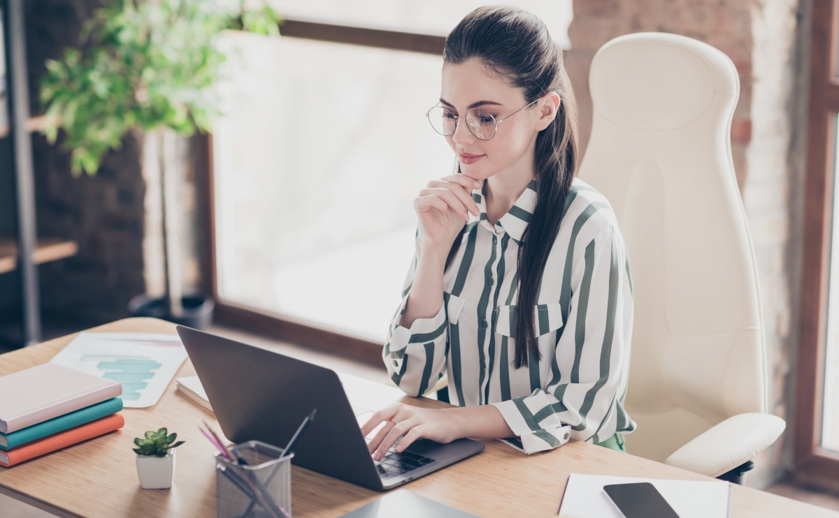 Portrait of focused intelligent start up expert girl working on laptop