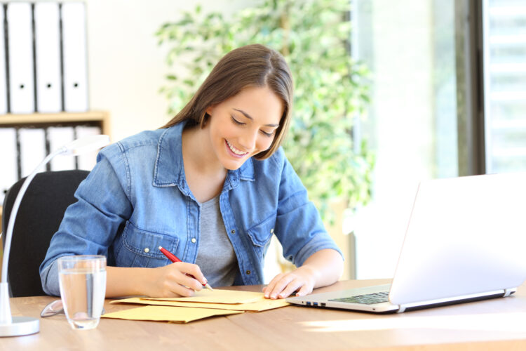 Entrepreneur writing address on an envelope