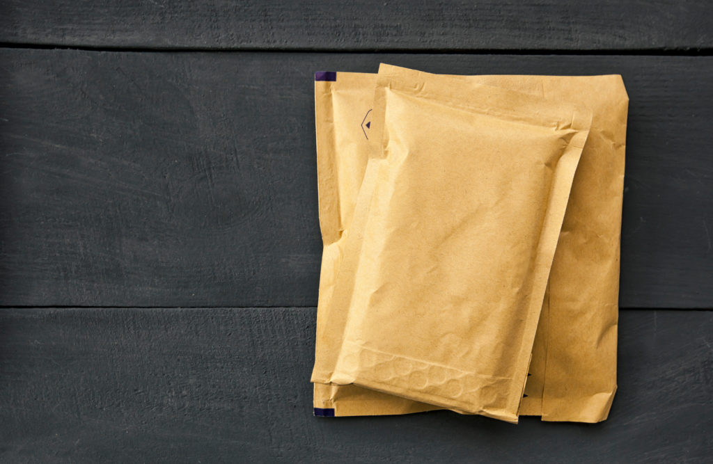 Two different size of paper envelopes on the wooden table