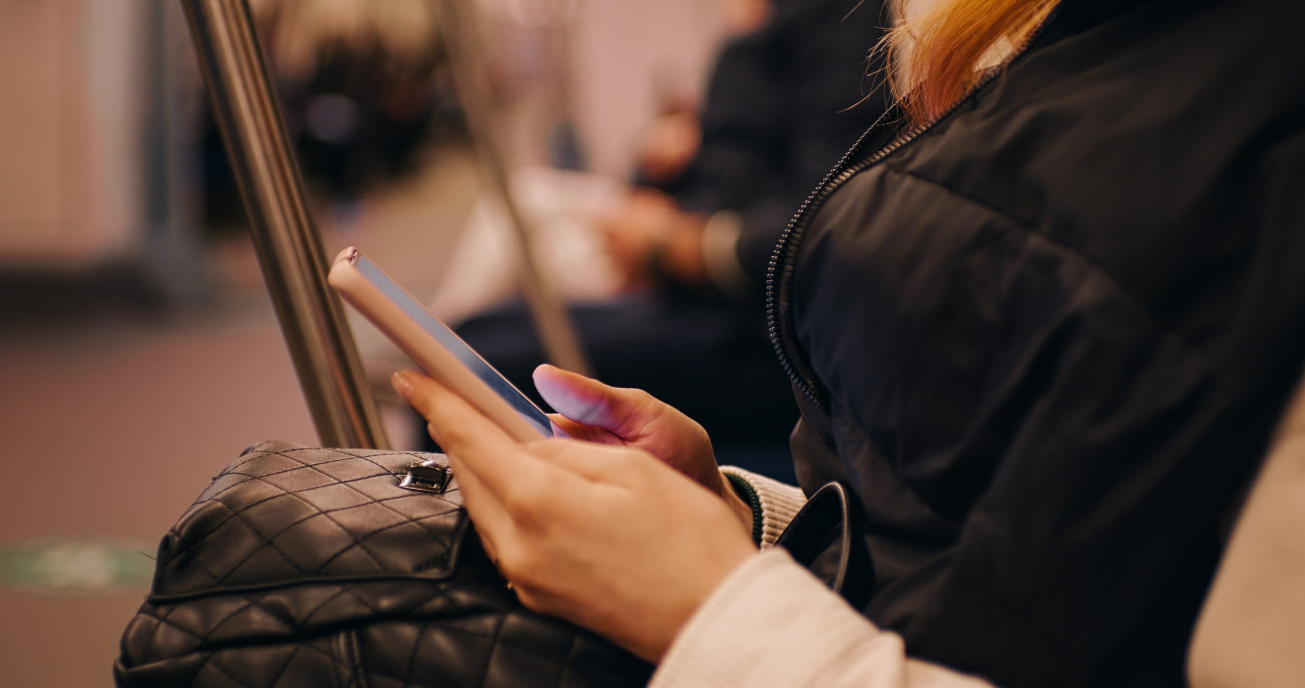female using smartphone in subway