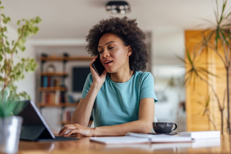 serious woman making a phone call from home.